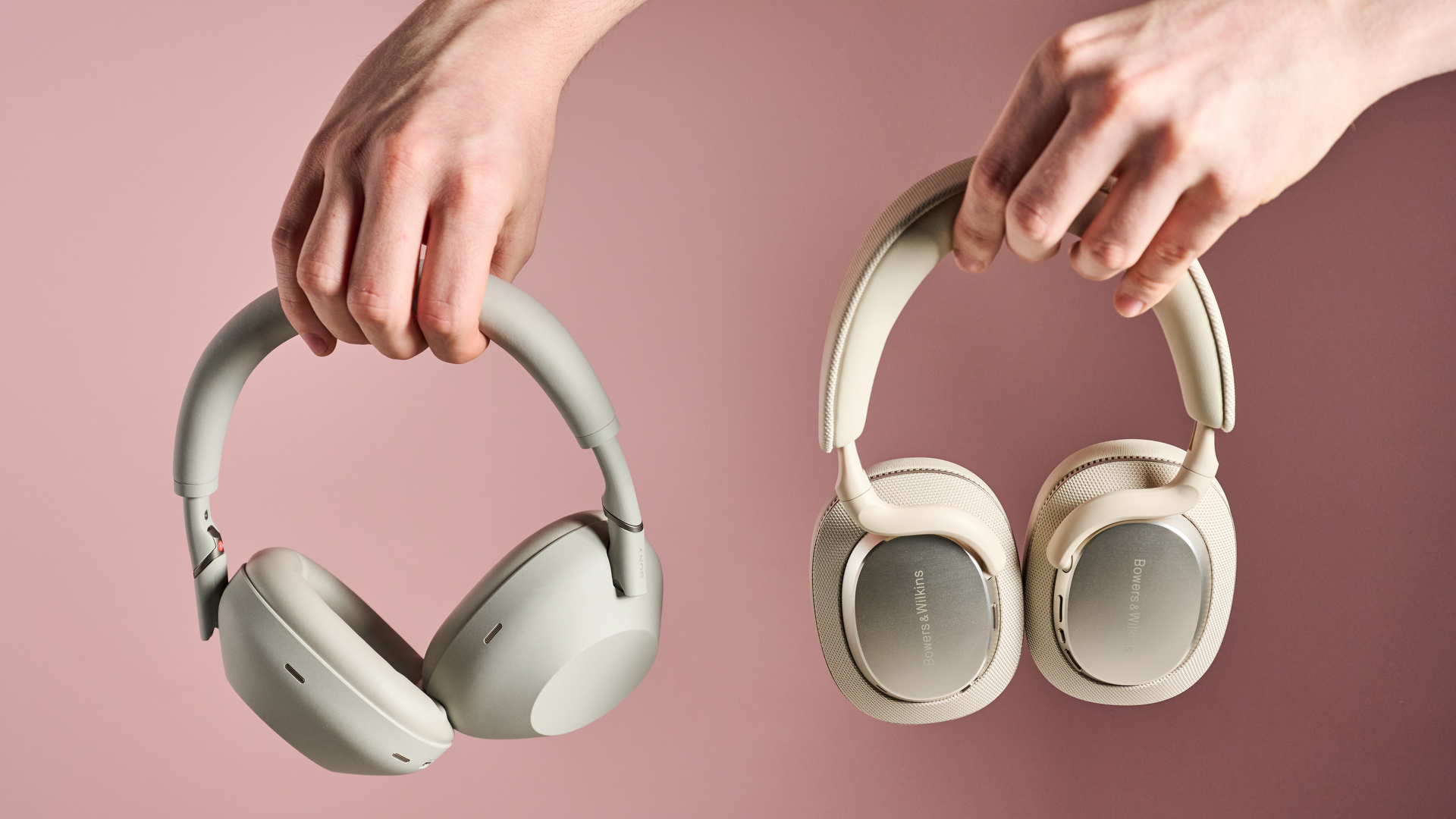 Person holding Sony WH-1000XM6 and Bowers & Wilkins Px7 S3
