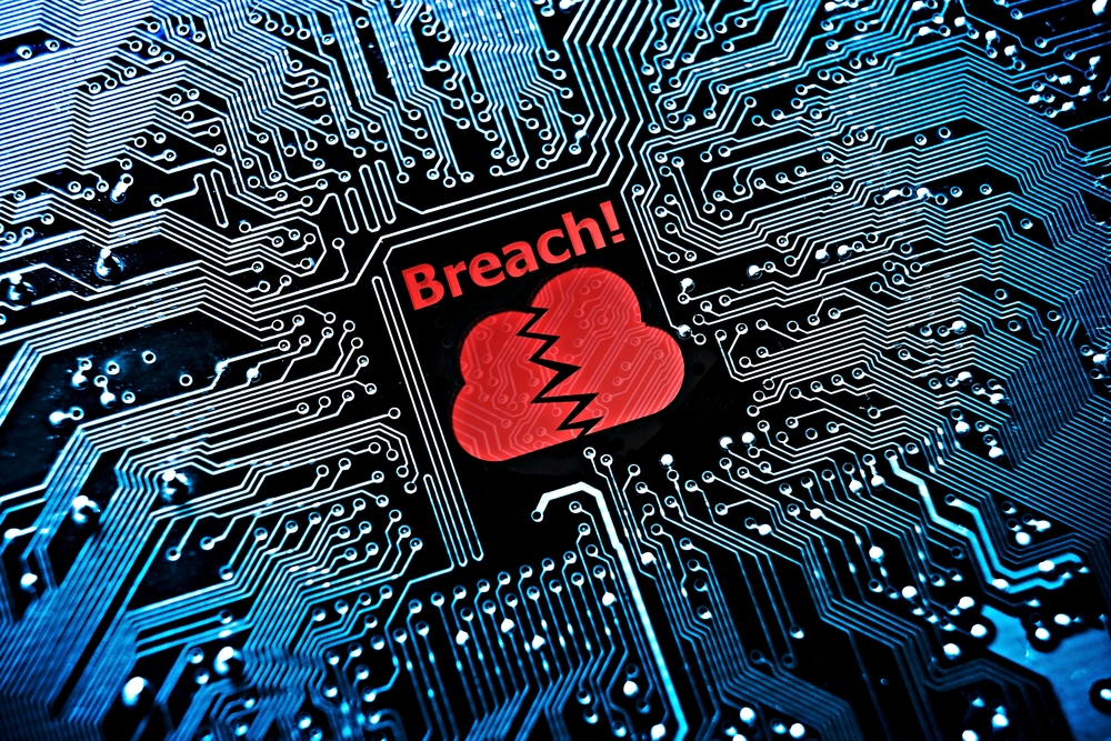 A processor with a red cloud broken in two with a word beneath: 'BREACH!'