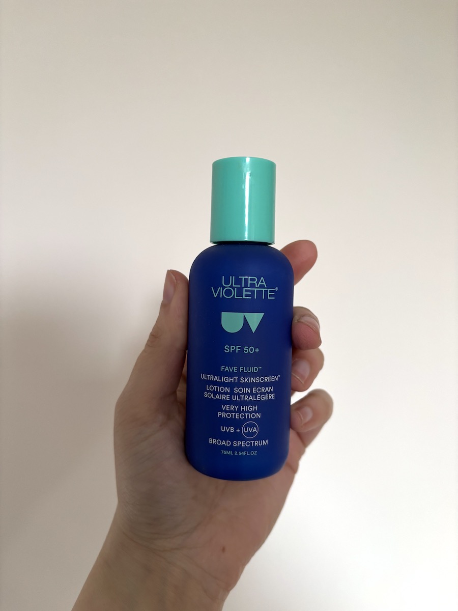 Mica Ricketts holding bottle of Ultra Violette Fave Fluid